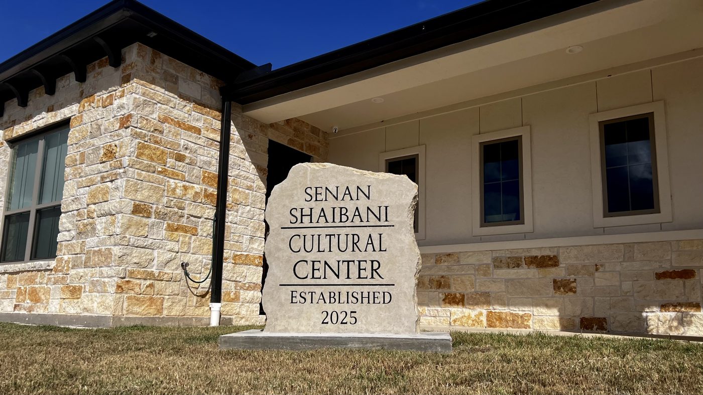 A carved limestone marker outside the center reading Senan Shaibani Cultural Center, Established 2025.